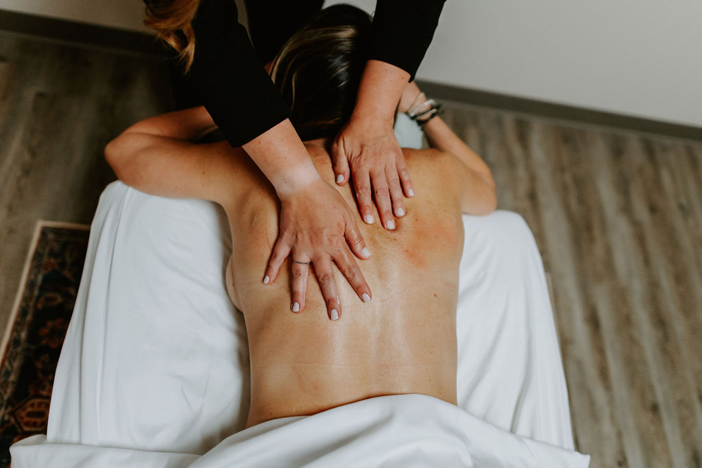 a person laying face down and getting a massage